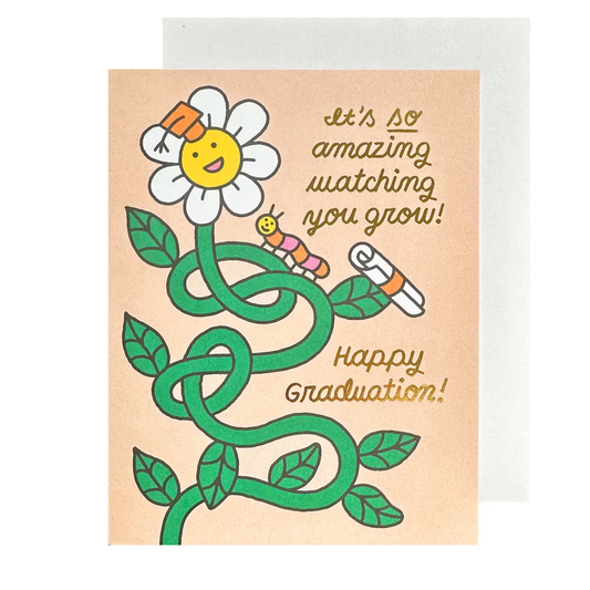 Graduation card with a flower and text 'It's so amazing watching you grow! Happy Graduation!' on a beige background.