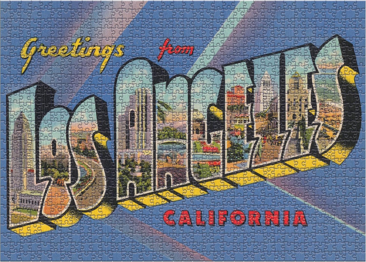 A completed jigsaw puzzle featuring a retro-style 'Greetings from Los Angeles, California' design. The puzzle shows colorful city landmarks inside the large 'LA' letters, set against a blue background with diagonal stripes and red text.