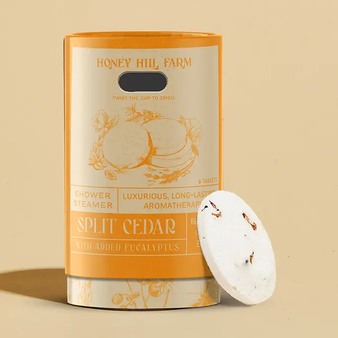 Honey Hill Farm Split Cedar shower steamer with packaging on a beige background