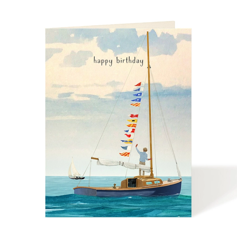 Birthday card with a sailboat illustration and colorful flags on a blue ocean background.