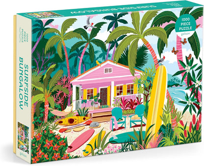 A 1000-piece jigsaw puzzle box titled 'Surfside Bungalow' by Puzzle Factory. The box art features a colorful tropical beach scene with a pink bungalow, palm trees, surfboards, and beach chairs.